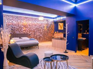 a bedroom with a bed and a table and chairs at Le Voluptueux - Sauna - Jacuzzi - Centre-Ville in Angers