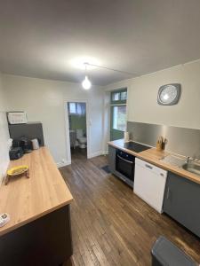 a kitchen with a table and a clock on the wall at La Cigalienne in Treignac