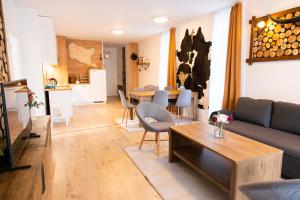 a living room with a couch and a table at Apartmán Vila Zuberec in Zuberec