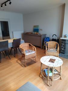 a living room with two chairs and a table at Residentie Rapallo in Middelkerke