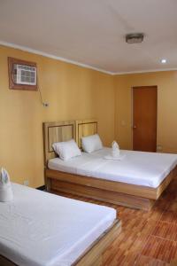 Postel nebo postele na pokoji v ubytování Agustin El Nido Inn