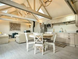 a kitchen and dining room with a table and chairs at East Farm Croft in Alnwick