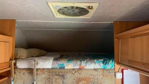a small room with a fan in the ceiling at Calima Glamping- Cozy Camper Retreat in Tefía