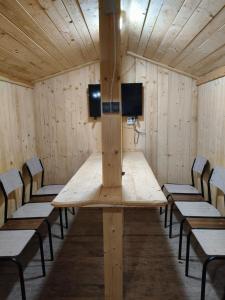 a conference room with a wooden table and chairs at Vila Bucovina in Ciocăneşti