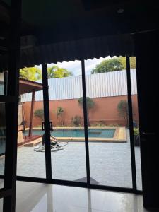 a view of a swimming pool through a window at Pool villa Phuket in Kata Beach