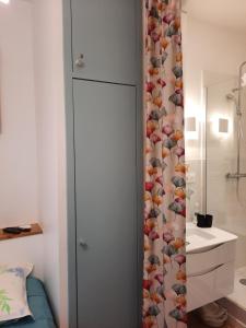 a bathroom with a shower curtain and a sink at LA GRANV'ILLAISE in Granville +54 photos