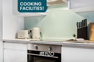 a kitchen with a stove and a sign that reads cooking facilities at Spacious 1-bed Apartment in Newark on-Trent by Renzo, Central Location, Free Parking! in Newark upon Trent +7 photos