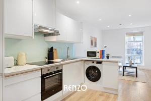 a kitchen with white cabinets and a dishwasher at Spacious 1-bed Apartment in Newark on-Trent by Renzo, Central Location, Free Parking! in Newark upon Trent