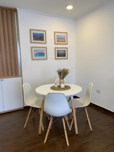 a white table with chairs and a vase of flowers on it at CerroSur in Yacimiento Río Turbio +19 photos