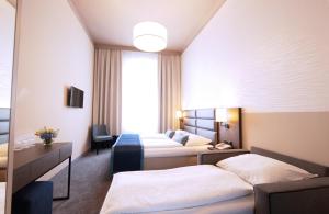 Postel nebo postele na pokoji v ubytování Drei Kronen Hotel Wien City