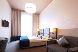 Postel nebo postele na pokoji v ubytování Drei Kronen Hotel Wien City