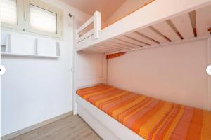 a bedroom with two bunk beds and a window at Casa Lella in Costa Rei