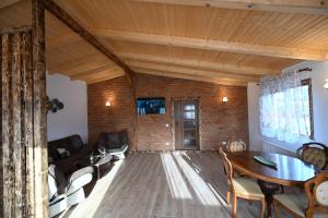 a living room with a table and a couch at Casa Pop in Râşnov +5 photos