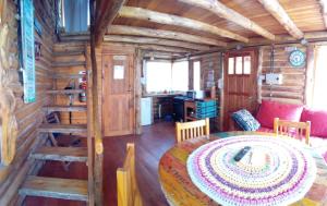 a dining room with a table in a log cabin at Cabañas - sierras de cordoba - Jose de la quintana #3 in José de la Quintana