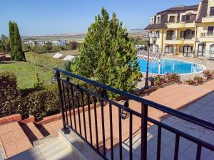 a balcony of a building with a swimming pool at Apartament Morela in Sunny Beach
