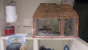 a brick oven is being built in a room at Departamento 11 - Av 1 - Grupo DEL SALVADOR in Las Toninas
