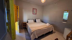a bedroom with a large bed in a room at Coroaci Beach House in Barra Grande