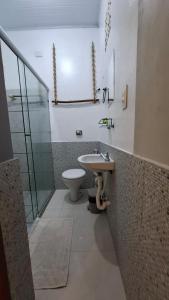 a bathroom with a sink and a toilet at Coroaci Beach House in Barra Grande