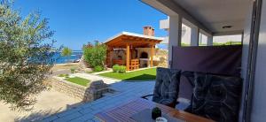 a house with a gazebo on a patio at Apartments Piazza in Nin