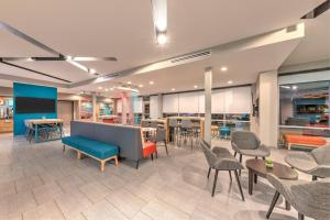 a lobby with chairs and tables and a cafeteria at avid hotel Austin NW - Lakeline by IHG in Austin