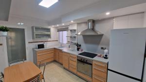 a kitchen with a refrigerator and a table in it at La Colonia Beach House in Águilas