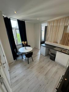 a living room with a table and a piano at Coeur de bruxelles in Brussels
