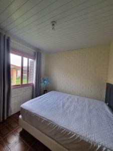 Postel nebo postele na pokoji v ubytování Casa com piscina em Arroio do Sal + 16 fotografií