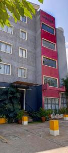 a large building with a red and gray at Raha Hotel & Suites in Nairobi