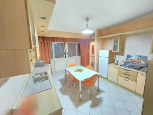 a kitchen with a table and a white table and chairs at Casa Francesco in Catania +30 photos