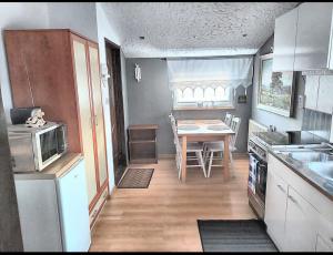 a small kitchen with a table and a dining room at Anielska Chatka in Olszanica
