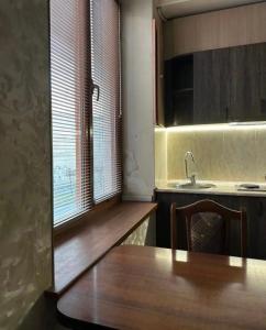 een keuken met een houten tafel en een wastafel bij Apartment Above The Cascade in The Heart of Yerevan in Jerevan
