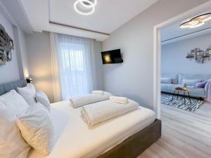 a bedroom with a bed with a large mirror at Golden Lake apartman in Keszthely