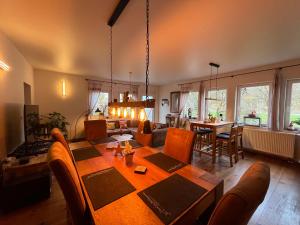 a living room with a table and a dining room at Casa Verde Sinnerthal in Neunkirchen