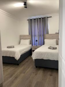 Postel nebo postele na pokoji v ubytování Sunny Side Apartment