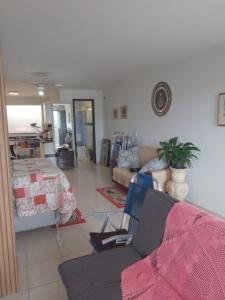 a living room with a couch and a table at Flat super top in Guaratuba