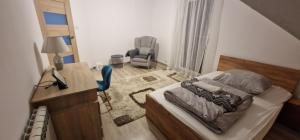 a bedroom with a bed and a desk and a chair at Cudowny zakątek BIS in Bukwica