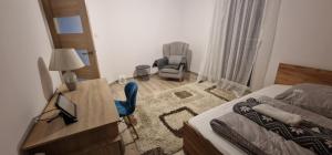 a bedroom with a desk and a bed and a chair at Cudowny zakątek BIS in Bukwica
