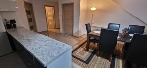 a kitchen and dining room with a table and chairs at Cudowny zakątek BIS in Bukwica