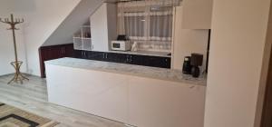 a kitchen with white cabinets and a counter top at Cudowny zakątek BIS in Bukwica +3 photos