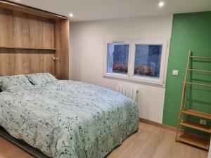 a bedroom with a bed and two windows at Mon Nid'éal de Bien-être in Saint-Forgeux +10 photos
