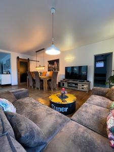a living room with a couch and a table at Casa Verde Sinnerthal in Neunkirchen