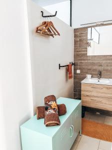 a bathroom with a blue bench and a sink at Vaikea Fare in Mahina +29 photos
