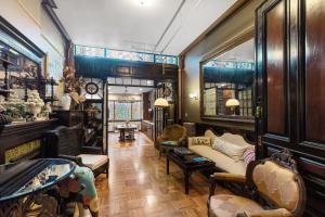 a living room with furniture and stained glass windows at Northern Lights Mansion in New York