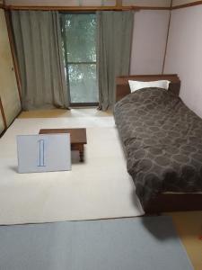 a bedroom with a bed and a box with the number on it at Yoshinogawa - House - Vacation STAY 98524v in Yoshinogawa