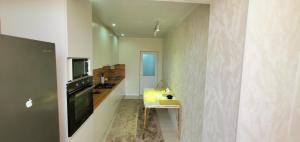 a kitchen with a sink and a television in a room at Квартира уют in Karakol +2 photos
