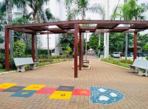 a pavilion with benches on a sidewalk in a park at Aeroporto de Guarulhos 3 in Guarulhos
