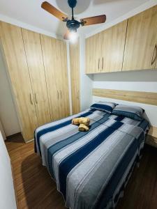 a teddy bear laying on a bed in a bedroom at Aeroporto de Guarulhos 3 in Guarulhos