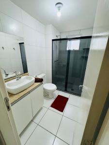 a bathroom with a toilet and a sink and a shower at Aeroporto de Guarulhos 3 in Guarulhos +24 photos