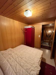 ベルヴァルトにあるChalet Waldesruhのベッド1台、赤い冷蔵庫が備わる小さな客室です。 +41枚の写真