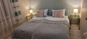 a bedroom with a large bed with two lamps at Villa Charlotte in Bad Liebenstein